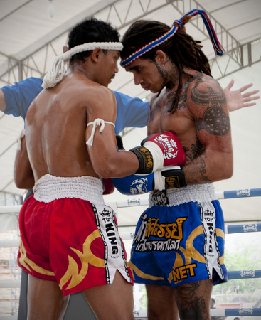 Muay Thai boxers during the pre-fight traditional round at the 9th World Thai Martial Arts Festival in Ayutthaya, Thailand.のeditorial素材