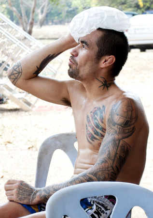 Muay Thai boxer rests after a fight at the 9th World Thai Martial Arts Festival in Ayutthaya, Thailand.のeditorial素材