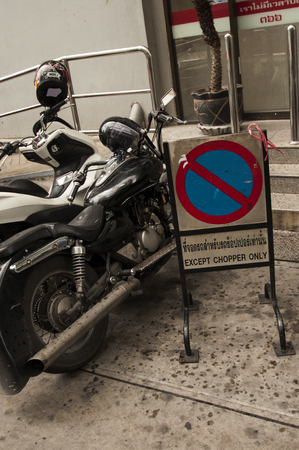 Funny parking sign reserves the spots for choppers only in a street of Bangkok, Thailand.のeditorial素材