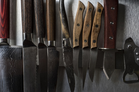 Set of cooking knives against a grey metal background.の写真素材