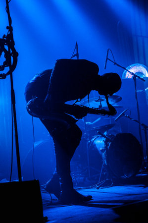 Silhouette of a rock band members playing live.