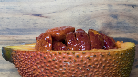 Half gac fruit on a wooden backgroundの写真素材