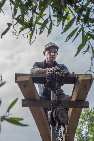 Vietnamese man works on bending long planks for boat making in Nga Bay in southern Vietnamのeditorial素材