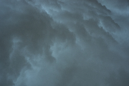 Dark monsoon clouds seen from the groundの写真素材