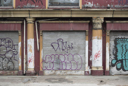 Shop facade with graffiti on the iron gates in a street of Jakarta, Indonesiaのeditorial素材