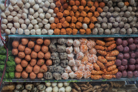 Closeup of fishballs, seafoodballs, and meatballs in a pushcart's windowの写真素材