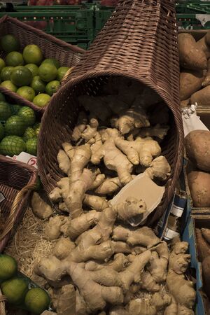 Ginger in a Cornucopia, green limes, and potatoes, on a display with prices in Euro in a French shopのeditorial素材