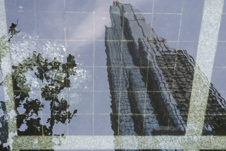 Reflection on water of Landmark 81 skyscraper viewed from the street in Ho Chi Minh City, Vietnam
