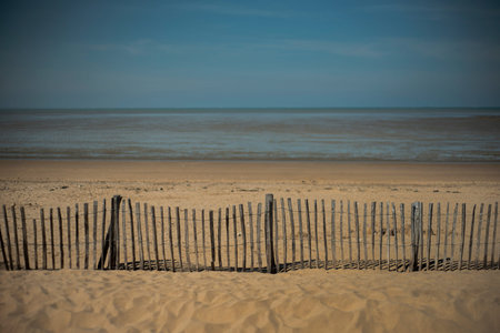 Chatelaillon-Plage beach on the French Atlantic coast, with a wooden fence on the foreground. Nobody...