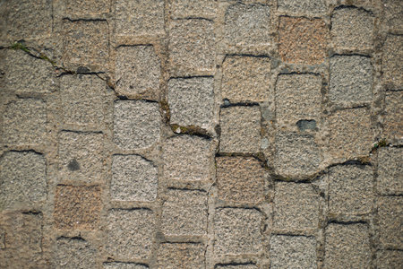Background close up of white large cobblestones from a street's pathway in La Rochelle, France.