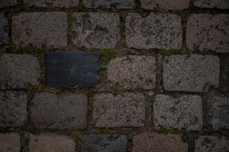 Closeup top view of cobblestones of different colors and textures from a medieval street in the French town of Angouleme.の写真素材