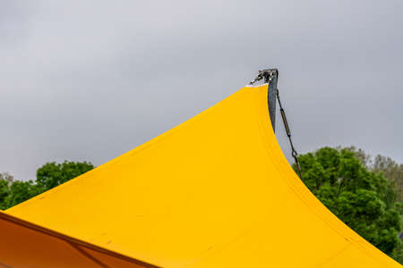 Yellow water-repellent awning in the park.の写真素材