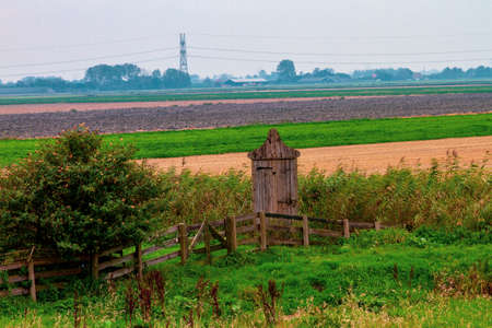 Outhouse with a traditional heart hole in the door in the gardenの写真素材