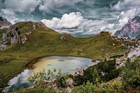 Valparola Pass with hut and with Lake Valparola in the foreground, Italy.の写真素材