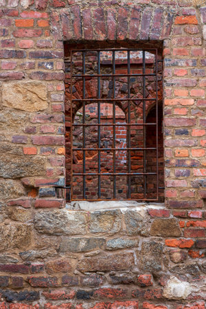 wall and window bars an old churchの写真素材