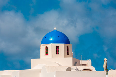 Greek white church with blue dome in Santorini.の写真素材