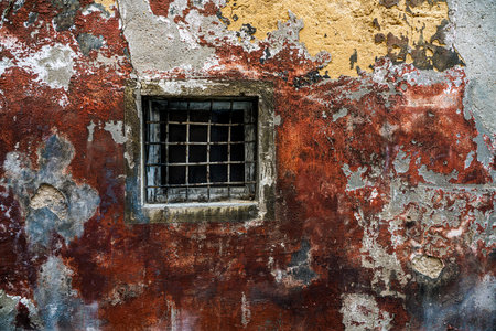 old house facade with window and grill