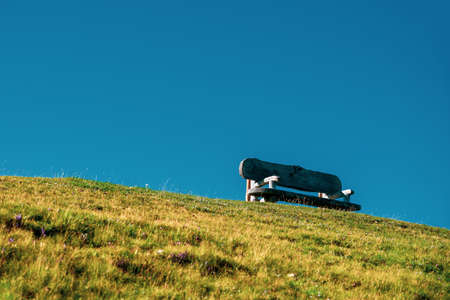 Wooden bench on hiking trails in the Dolomites, Italy.の写真素材