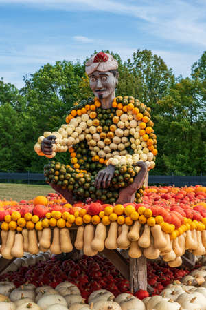 Wooden figure decorated with pumpkinsの写真素材