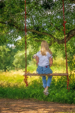 Young woman with a white dog on a tree swing.の写真素材