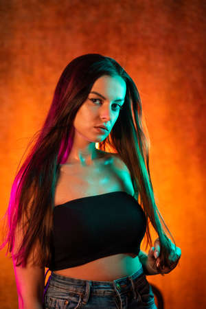 Portrait shot of a pretty young woman in RGB colors.の写真素材