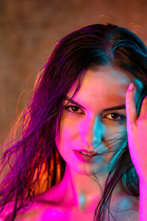 Portrait shot of a pretty young woman in RGB colors.