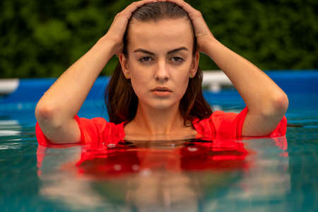 Portrait of a beautiful woman in the swimming pool.の写真素材