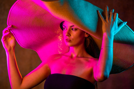 Portrait shot of a pretty young woman in RGB colors.