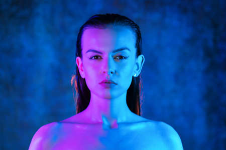 Portrait shot of a pretty young woman in RGB colors.の写真素材