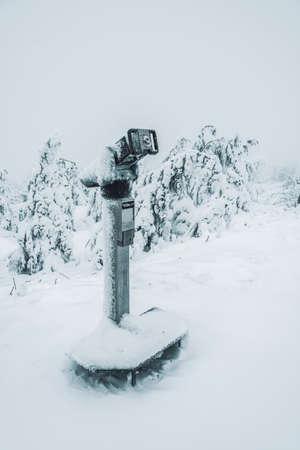 snow-covered coin operated binoculars, Oberwiesenthal Germany.の写真素材