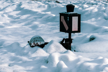 Switch lever a snow-covered railroad switch.の写真素材