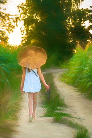 Young beautiful woman with summer hat in the corn field.の写真素材
