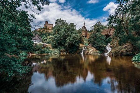 Pyrmonter MÃ¼hle at Elzbachfall with the castle in the background, Germany.のeditorial素材