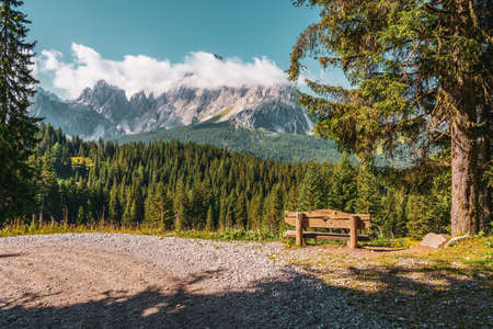 Wooden bench on hiking trails in the Dolomites, Italy.の写真素材