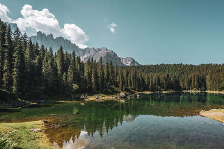Lake Carezza, view on the lake with the Latemar range in the background. Italy.の写真素材