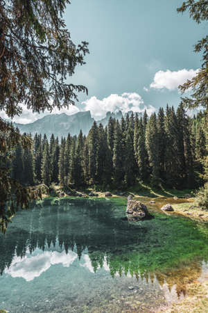 Lake Carezza, view on the lake with the Latemar range in the background. Italy.の写真素材