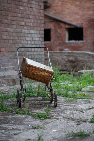 Old antique baby carriage on a farmの写真素材
