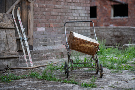 Old antique baby carriage on a farmの写真素材