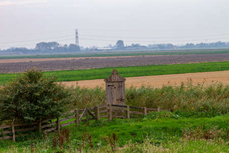 Old outhouse in the field, Netherlandsの写真素材