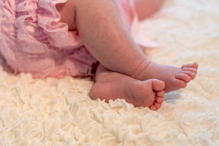 baby feet on white blanketの写真素材