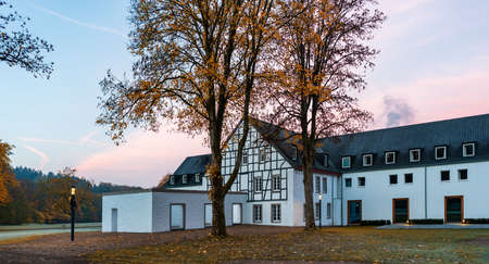 White house in the park in autumnの写真素材