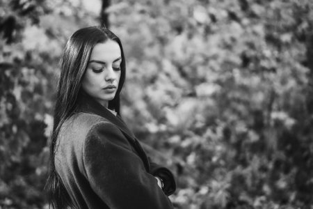 Portrait of a young woman in the park in black and whiteの写真素材