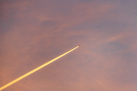 Airliner at high altitude with condesation trailsの写真素材