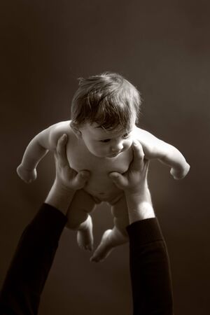 a father lifting up his babyの写真素材
