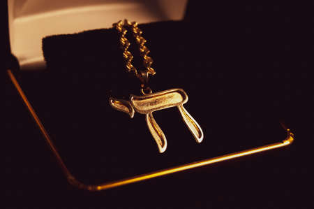 gold necklace with a chai pendantの写真素材