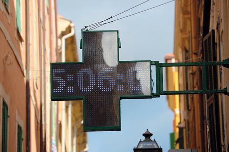 Neon Pharmacy Sign with the Time 5:06 in Italiaの写真素材