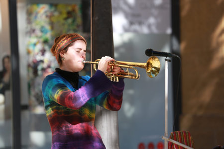Aix-En-Provence, France - October 21, 2016: Young Woman Playing the Trumpet in the Street (Cours Mirabeau) in Aix-En-Provence, Franceのeditorial素材