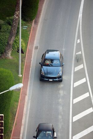 Monte-Carlo, Monaco - September 30 2018 : Aerial View Of A Beautiful Porsche Cayenne SUV (Top View) Driving On The Boulevard Du Larvotto In Monaco, French Rivieraのeditorial素材