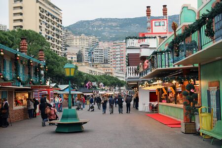 Monte-Carlo, Monaco - December 13, 2018:  People Walking In The Christmas Village. Monaco Christmas Market 2018 In The French Riviera, Europeのeditorial素材