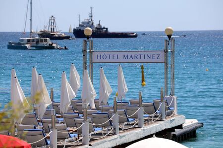 Cannes, France - May 14, 2019: The Grand Hyatt Cannes Hotel Martinez Pier Luxury Empty Chairs, Luxurious Yachts On The Mediterranean Sea In The Background In France, French Riviera, Europeのeditorial素材